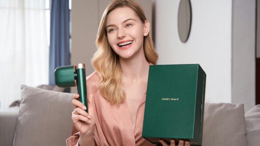 a woman holding a hair dryer and a box