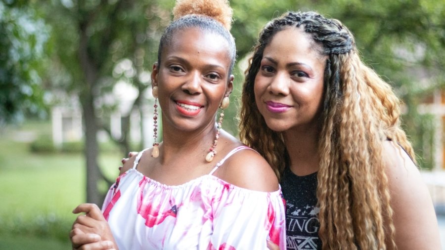 2 women smiling during daytime